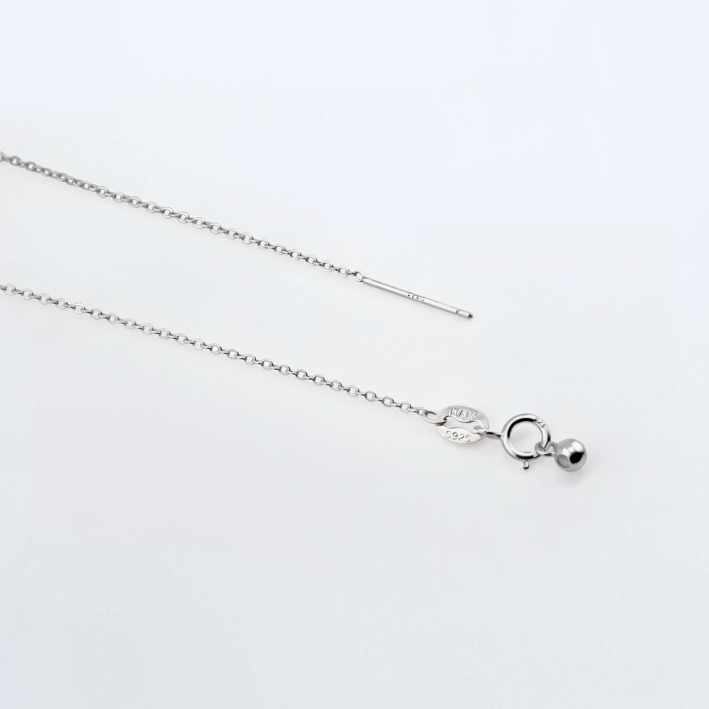 Dainty adjustable sterling silver chain necklace. It shows the ends of the adjustable pin, ball and clasp laying flat on a plain white background.