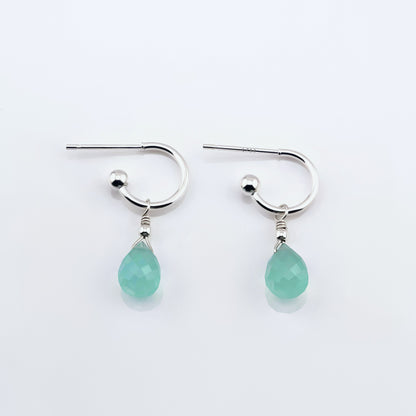 Pair of sterling silver interchangeable mini hoop earrings, with blue-green teal AAA quality aqua chalcedony teardrop shaped briolette gemstones  on a plain white background, top view.