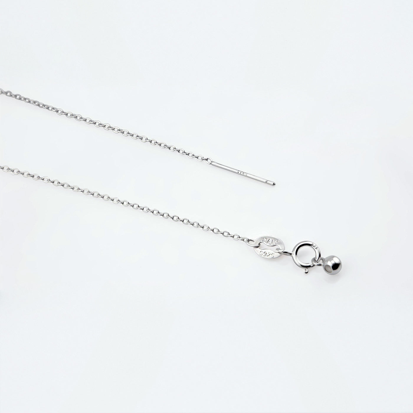 Dainty adjustable sterling silver chain necklace. It shows the ends of the adjustable pin, ball and clasp laying flat on a plain white background.