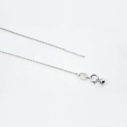 Dainty adjustable sterling silver chain necklace. It shows the ends of the adjustable pin, ball and clasp laying flat on a plain white background.