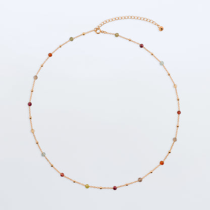 Estelle dainty high quality natural multi-colored gemstone beaded chain adjustable necklace 14K gold filled, top view laying flat on a plain white background. Featuring high quality AAA Apatite, Agate, Citrine, Garnet, Labradorite, Obsidian, Peridot gemstones.
