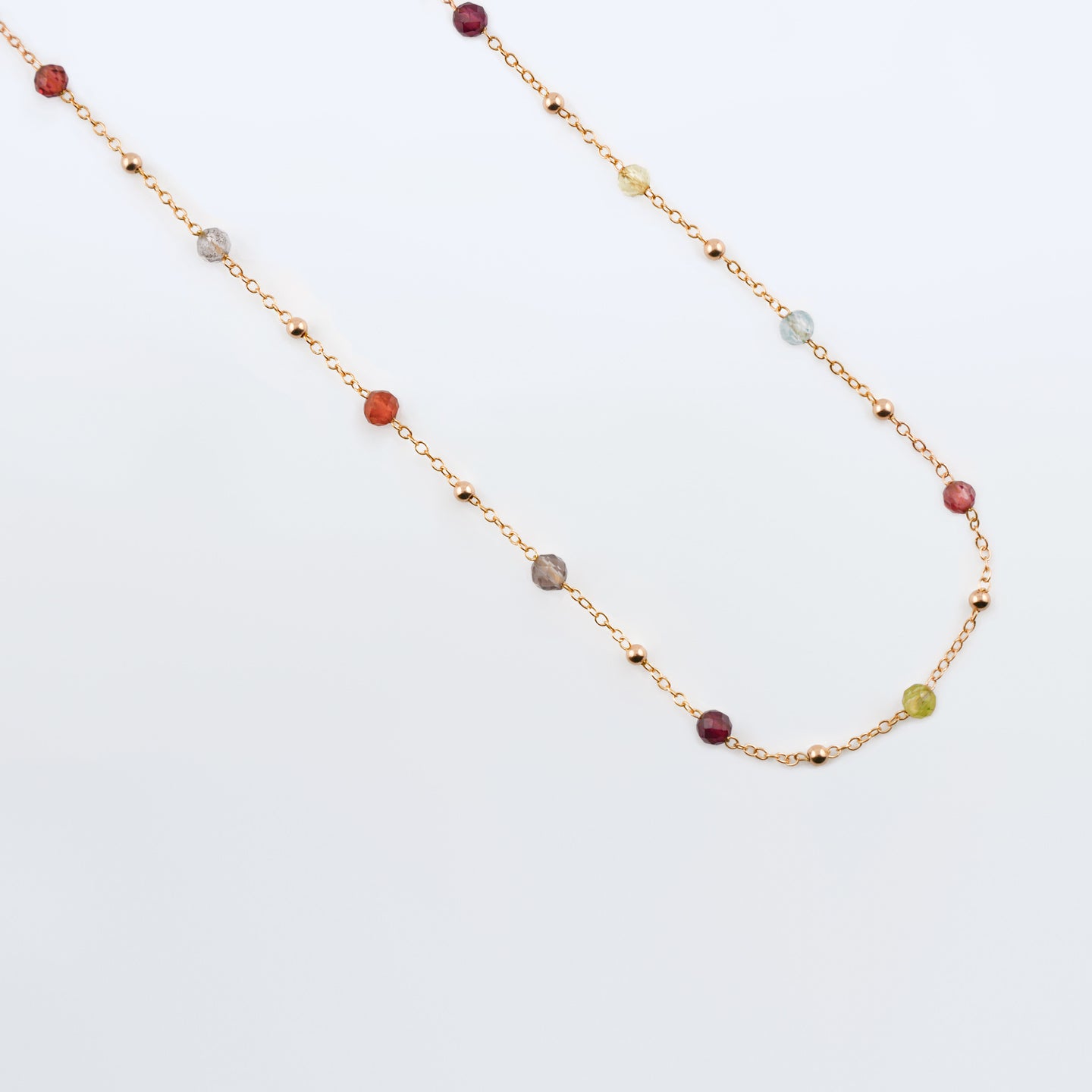 Estelle dainty high quality natural multi-colored gemstone beaded chain adjustable necklace 14K gold filled, top view with plain background closer view. Featuring high quality AAA Apatite, Agate, Citrine, Garnet, Labradorite, Obsidian, Peridot gemstones.