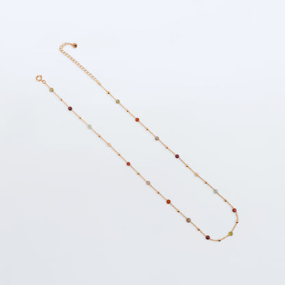 Estelle dainty high quality natural multi-colored gemstone beaded chain adjustable necklace 14K gold filled, top view with plain background. Featuring high quality AAA Apatite, Agate, Citrine, Garnet, Labradorite, Obsidian, Peridot gemstones.