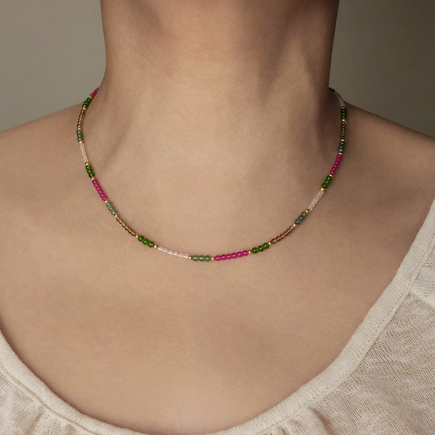 Hana dainty high quality garden multi-colored gemstone beaded adjustable necklace 14K gold filled, shown worn around a model's neck.