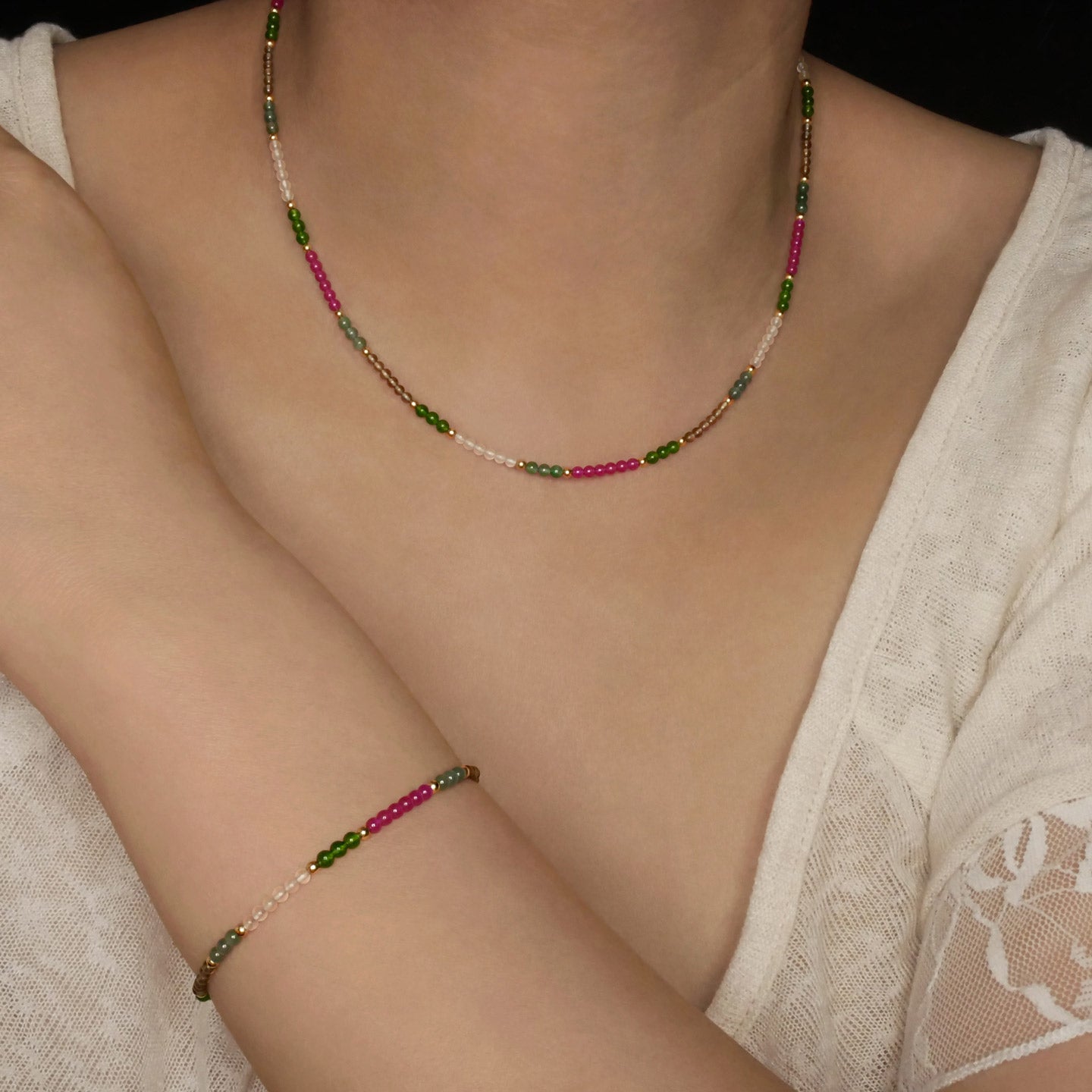 Hana dainty high quality garden multi-colored gemstone beaded adjustable necklace 14K gold filled, shown worn around a person's neck and wrist. Pink Ruby, Green Guatemalan Jade, Green Taiwan Jade, Smokey Quartz, Rose Quartz high quality AAA beads.