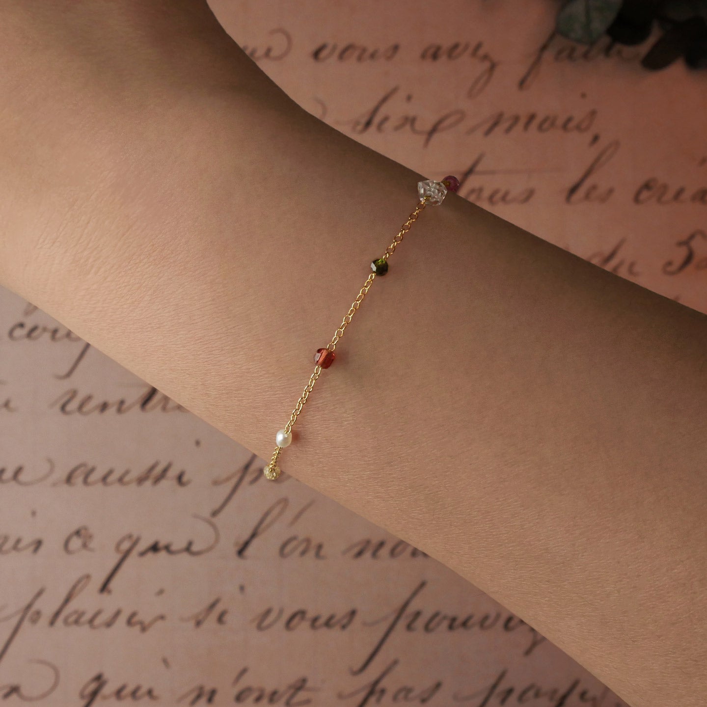 Lenora high quality natural multi-colored gemstone beaded chain bracelet 14K gold filled, shown worn on a model's wrist.