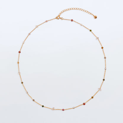 Lenora high quality natural multi-colored gemstone beaded chain adjustable necklace 14K gold filled, top view with plain background. Featuring high quality AAA Herkimer Diamond Quartz, Garnet, Rainbow Tourmaline, Natural Freshwater Rice Pearls and Smokey Quartz gemstones.