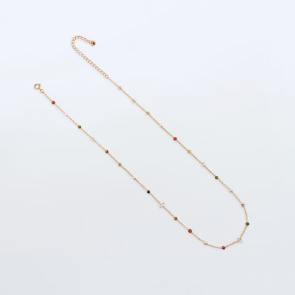 Lenora high quality natural multi-colored gemstone beaded chain adjustable necklace 14K gold filled, top view with plain white background. Featuring high quality AAA Herkimer Diamond Quartz, Garnet, Rainbow Tourmaline, Natural Freshwater Rice Pearls and Smokey Quartz gemstones.